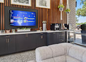 Thumbnail 11 of 20 - Outdoor entertainment area with coffee station and tv at Skyline at Barton Creek Apartments, Austin, 78758
