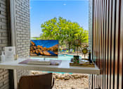 Thumbnail 13 of 20 - Workspace desk with scenic outdoor view at Skyline at Barton Creek Apartments, Austin, Texas