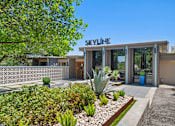 Thumbnail 9 of 20 - Property entrance with decorative breeze block wall at Skyline at Barton Creek Apartments, Texas