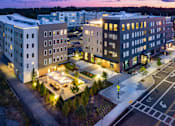 Thumbnail 23 of 23 - A building with a parking lot in front of it.