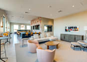Thumbnail 12 of 23 - A modern living room with a large painting on the wall.