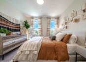 Thumbnail 4 of 23 - A bedroom with a large bed and a window with curtains.