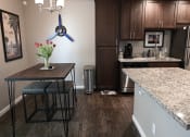 Thumbnail 10 of 16 - a kitchen with a table and two stools