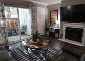 Thumbnail 13 of 16 - a living room with a tv and a fireplace