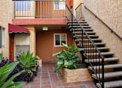 Thumbnail 5 of 18 - Red tile walkway and green plants