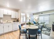 Thumbnail 11 of 12 - a kitchen with white cabinets and a table and chairs at Parks Residential - Denver, Centennial, CO 80111