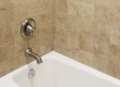 Thumbnail 11 of 23 - a bathroom with a bath tub