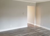 Thumbnail 9 of 23 - an empty living room with wood floors