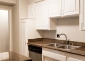 Thumbnail 7 of 23 - a kitchen with white cabinets