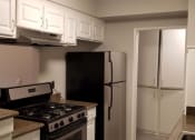 Thumbnail 6 of 23 - a kitchen with white cabinets