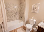 Thumbnail 47 of 54 - a bathroom with a toilet and a tub and a shower