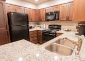 Thumbnail 45 of 54 - a kitchen with black appliances and granite counter tops