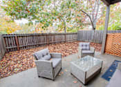 Thumbnail 41 of 54 - a patio with chairs and a table in front of a fence