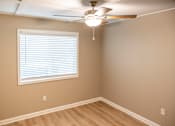 Thumbnail 18 of 19 - A room with a ceiling fan and a window with blinds.