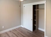 Thumbnail 13 of 19 - A white door is open to a pantry with shelves.