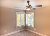 Thumbnail 15 of 19 - A room with a ceiling fan and a window with blinds.