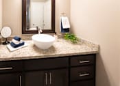 Thumbnail 18 of 56 - A bathroom with a white sink and a mirror.
