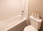 Thumbnail 35 of 56 - A white toilet with a toilet paper holder with four rolls of toilet paper.