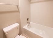 Thumbnail 19 of 56 - A white toilet and sink in a bathroom.