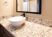 Thumbnail 33 of 56 - A white sink is on a marble countertop.