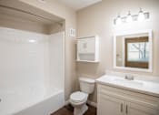 Thumbnail 44 of 61 - A white bathroom with a toilet, sink, and shower.