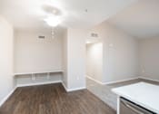 Thumbnail 58 of 61 - A room with a white table and wooden floor.