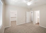 Thumbnail 59 of 61 - A white bedroom with a carpeted floor and a ceiling fan.
