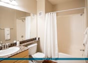 Thumbnail 34 of 61 - A bathroom with a sink, toilet, and bathtub.