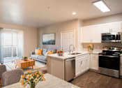 Thumbnail 26 of 61 - A modern kitchen with a dining table and chairs.