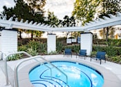 Thumbnail 7 of 61 - A small pool with a white fence and a white pergola.