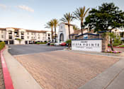 Thumbnail 2 of 61 - A sign for Vista Pointe Apartment Homes is in front of a building.