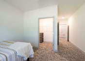 Thumbnail 64 of 66 - A bedroom with a bed, dresser, and closet.
