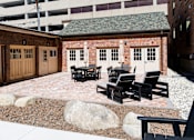 Thumbnail 5 of 81 - A patio with black chairs and a table.