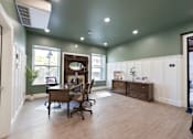 Thumbnail 15 of 81 - A room with a desk and a chair.