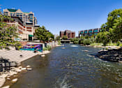 Thumbnail 18 of 81 - A river flows through a city with buildings on both sides.