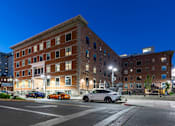 Thumbnail 9 of 81 - A building with a car parked in front of it.