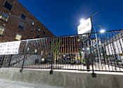Thumbnail 10 of 81 - A building with a sign that says "ONE18" is shown at night.