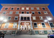 Thumbnail 7 of 81 - The building is well lit up with lights and has a signboard on it.