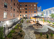 Thumbnail 11 of 81 - A courtyard with a fountain and a gazebo surrounded by buildings.