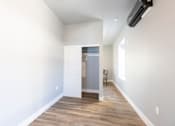 Thumbnail 45 of 81 - A room with a white door and a window on the right side.