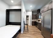 Thumbnail 46 of 81 - A modern kitchen with wooden cabinets and stainless steel appliances.