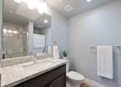 Thumbnail 51 of 81 - A bathroom with a white towel hanging on a rack.