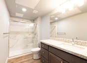 Thumbnail 56 of 81 - A bathroom with a marble shower, toilet, and sink.