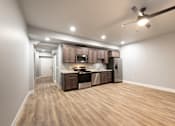 Thumbnail 58 of 81 - A spacious kitchen with wooden flooring and modern appliances.