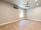 Thumbnail 66 of 81 - A room with a ceiling fan and a window.
