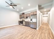Thumbnail 67 of 81 - A kitchen with stainless steel appliances and wooden floors.