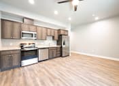 Thumbnail 68 of 81 - A kitchen with wooden cabinets and a stainless steel refrigerator.