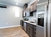 Thumbnail 78 of 81 - A kitchen with stainless steel appliances and wooden cabinets.