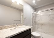 Thumbnail 80 of 81 - A bathroom with a marble sink and toilet.