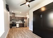 Thumbnail 81 of 81 - A modern kitchen with dark wood cabinets and a ceiling fan.